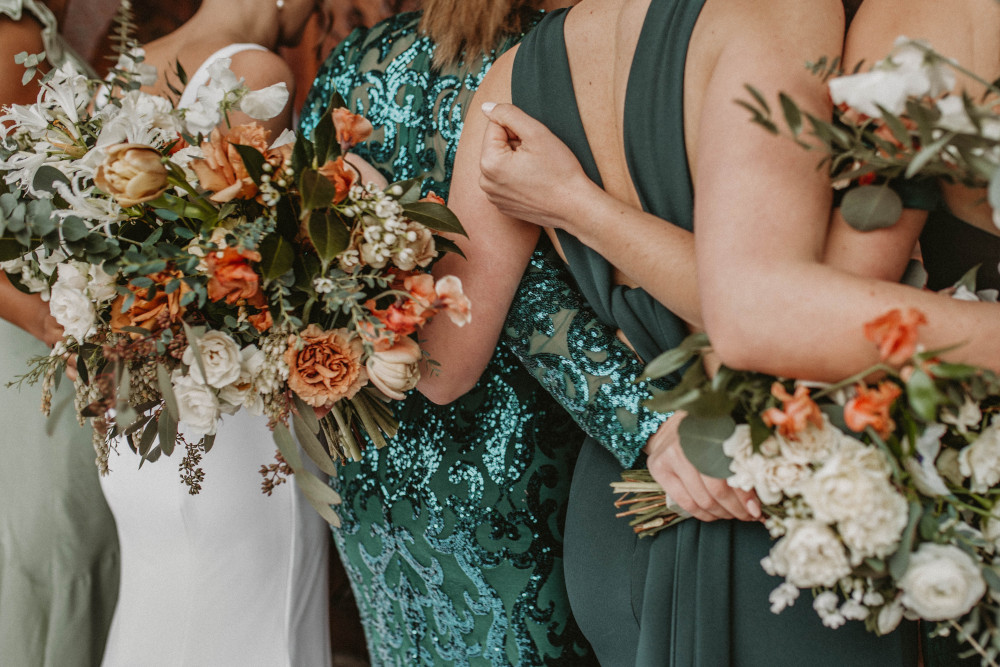 Photo of bride and bridesmaids with back to the camera by Taylor Gray on Unsplash